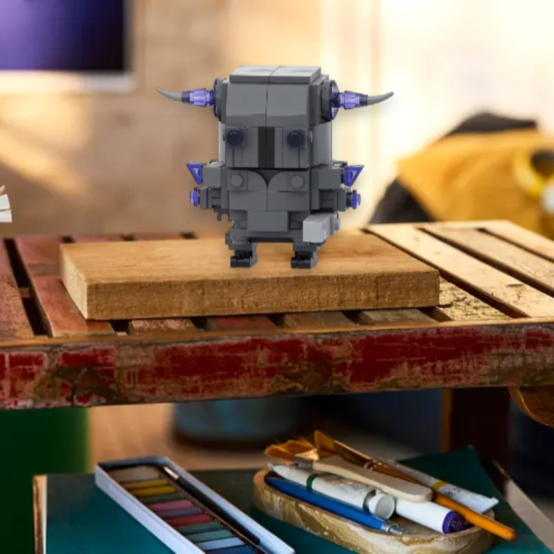 Small robot figurine on a wooden surface with books and stationery items in the background